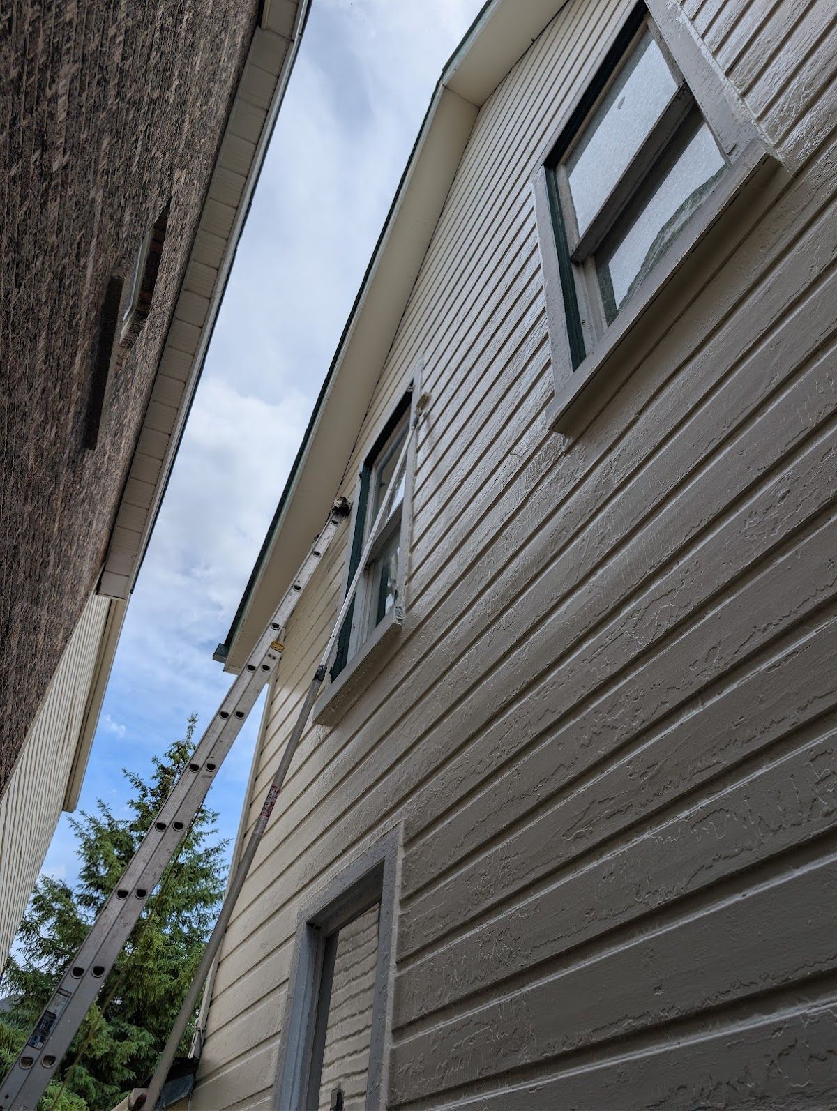 Exterior repaint in progress on a GTA home