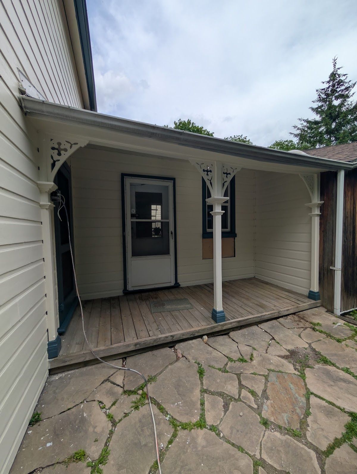 Repainted covered porch with crisp white columns